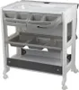 A white and gray baby changing table with an integrated bathtub and storage compartments, shown on a white background. Produktbild-Vorschau
