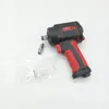 A black and red air impact wrench with a small silver adapter and a clear plastic bag containing a white adapter, all on a white background. Anteprima dell’immagine prodotto