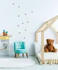 A child's bedroom with a bed, chair, and small table. Produktbild-Vorschau