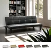 A black futon sofa is shown in a living room setting with a bookshelf in the background and a window with natural light. Below the main image, there are smaller images showing the same sofa in different colors. Produktbild-Vorschau