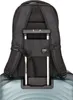 The back of a black backpack is shown attached to the handle of a light blue suitcase. Produktbild-Vorschau