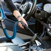 A person's hand is using a vacuum cleaner hose to clean the interior of a car. Náhľad obrázku produktu