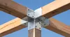 A close-up view of a metal corner bracket connecting four wooden beams, set against a clear blue sky. Produktbild-Vorschau