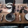 A beautifully set dining table with place settings, floral arrangements, and candles. Náhled obrázku produktu