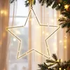 A star-shaped light decoration hangs in front of a window with sheer curtains, surrounded by Christmas tree branches and fairy lights. Anteprima dell’immagine prodotto