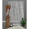 A decorative room divider made of white branches stands behind a wooden vase with dried branches and cotton, a black lantern with a candle, and a potted plant. Náhled obrázku produktu