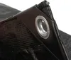 Close-up of a black tarp corner with a metal grommet. Produktbild-Vorschau