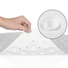 A hand is shown lifting a corner of a white, textured bath mat, revealing its underside with suction cups. A magnified inset shows a close-up of one of the suction cups. Voir les images du produit