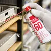 A gloved hand sprays a cleaning product onto electronic connectors. Produktbild-Vorschau
