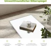A mirror on a rug with a candle and books on it. Produktbild-Vorschau