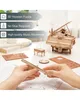 A person assembling a 3D wooden toy piano, with other parts and a finished piano on a table. Podgląd zdjęcia produktu