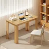 A wooden desk with a laptop, books, and a lamp, next to a chair and a bookshelf. Náhled obrázku produktu