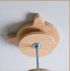 A close-up view of a wooden cat tree attachment mounted on a white ceiling. Produktbild-Vorschau