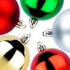 A close-up, overhead view of several Christmas ornaments arranged in a circle against a white background. Náhled obrázku produktu