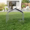 A wire cage with a black roof sits on a green lawn in a backyard setting. In the background, there is a modern house with outdoor furniture. Anteprima dell’immagine prodotto
