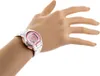 A close-up shot of a woman's wrist wearing a digital watch. Produktbild-Vorschau