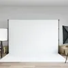 A photography studio setup with a white backdrop, lighting equipment, and cardboard boxes. Produktbild-Vorschau