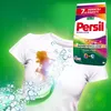 A white t-shirt with a stain is shown next to a bag of Persil laundry detergent. Bubbles and green swirls suggest cleaning action. Náhled obrázku produktu