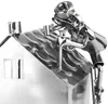 A close-up of a metal figurine of a house with a roofer on top, made from nuts and bolts. Náhľad obrázku produktu