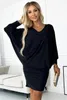 A woman wearing a black dress and holding a clutch. Anteprima dell’immagine prodotto