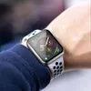 A close-up shot of a person's wrist wearing an Apple Watch with a perforated band. The watch face displays various metrics and icons. Produktbild-Vorschau