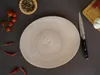 A top-down view of a plate with ingredients and a knife arranged around it. Produktbild-Vorschau