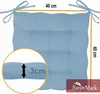 A light blue seat cushion with ties, showing dimensions and thickness. Produktbild-Vorschau