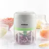 A portable mini-chopper is shown in the center of the image, with bowls of chopped ingredients surrounding it. Náhľad obrázku produktu