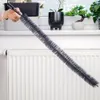 A person is holding a long, flexible brush over a white radiator. Podgląd zdjęcia produktu