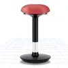 A red and black ergonomic wobble stool is shown on a white background with a grid pattern on the floor. Anteprima dell’immagine prodotto