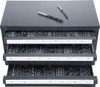A gray metal cabinet with three drawers filled with drill bits. Two drill bits are placed on top of the cabinet. Produktbild-Vorschau