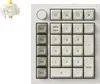 A white mechanical numpad with a separate mechanical switch shown in the top left corner. Produktbild-Vorschau