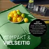 A green beanbag chair with a bowl of lemons and limes on it, and a tray with drinks in the background. Náhled obrázku produktu