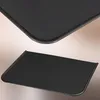 Two views of a black metal hearth plate, one close-up showing the rounded corner and edge, and another showing the full plate at an angle. Anteprima dell’immagine prodotto