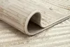 A close-up view of a rolled-up rug, showing its texture and striped pattern. Produktbild-Vorschau