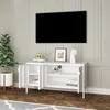 A white media console with open doors, displaying shelves and items, is placed against a paneled wall with a television mounted above it. A potted plant sits to the left. Náhľad obrázku produktu