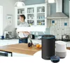 A man stands in a modern kitchen, holding a mug, with smart speakers visible on the counter. Produktbild-Vorschau