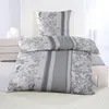 A neatly made bed with a duvet and pillow featuring a floral pattern in shades of gray and white. Produktbild-Vorschau