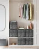 A closet interior with shelves displaying storage boxes, folded clothes, and hanging garments. Produktbild-Vorschau
