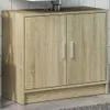 A wooden cabinet with two doors, likely a bathroom vanity, is shown in a neutral setting. Produktbild-Vorschau