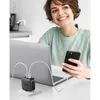 A woman is smiling while holding a smartphone and looking at a laptop, with a UGREEN charger plugged into the laptop and charging both devices. Anteprima dell’immagine prodotto
