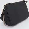 A black Guess handbag with a gold chain strap is shown against a white background. Produktbild-Vorschau