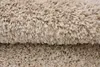 A close-up view of a beige shaggy rug, showing its texture and fibers. Anteprima dell’immagine prodotto