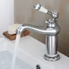 A vintage-style faucet is shown in a bathroom sink with water running. Produktbild-Vorschau