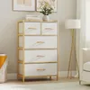 A chest of drawers with fabric drawers and a bamboo frame, placed in a room setting with a floor lamp and a sofa. Podgląd zdjęcia produktu