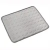A light gray cooling mat with a pattern of circles, bordered by a darker gray edge, is shown on a white background. Produktbild-Vorschau
