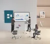 People in a modern office setting using mobile standing desks and a presentation screen. Anteprima dell’immagine prodotto