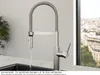 A kitchen faucet with water running, set against a modern kitchen backdrop with a window view. Anteprima dell’immagine prodotto