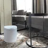 A white sensor trash can is placed on a patterned rug next to a modern sofa and a round side table in a living room setting. Anteprima dell’immagine prodotto