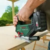 A person is using a cordless jigsaw to cut a piece of wood outdoors. Voir les images du produit